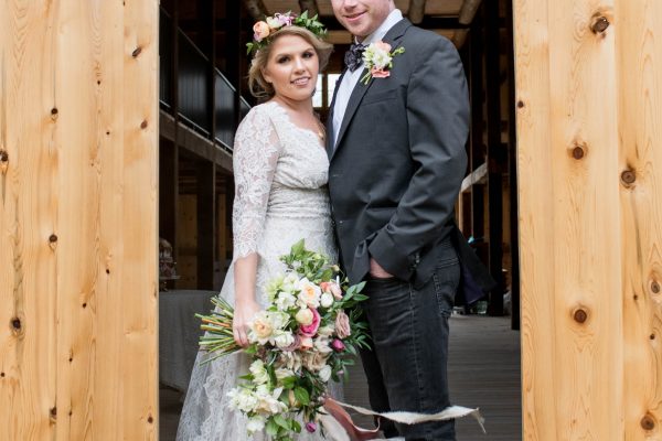 Bride and groom in barn doorway