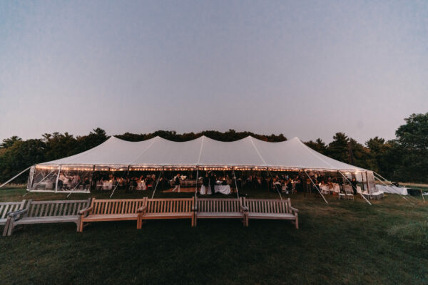 Tent in field at twilight wedding